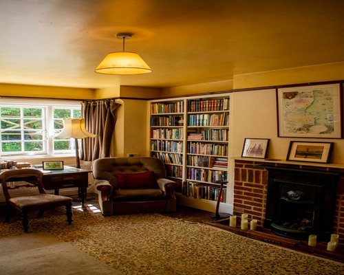 Person reading a book in a comfortable room with warm lighting