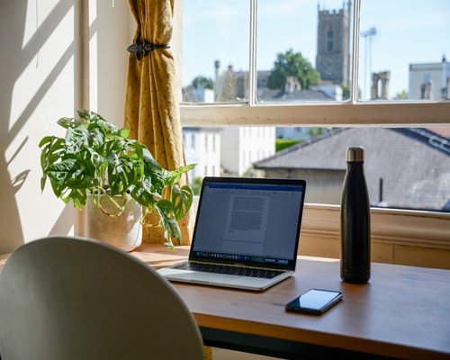 Organized work desk with water and natural light